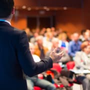 Speaker,At,Business,Conference,And,Presentation.,Audience,At,The,Conference